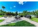 Outdoor amenity area offers a peaceful view of the pond, with seating, grills, and lush greenery around at 264 Woods Point Rd, Osprey, FL 34229