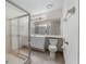 Clean bathroom with a glass-enclosed shower, neutral tile, and modern fixtures at 264 Woods Point Rd, Osprey, FL 34229