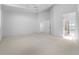 Spacious bedroom boasts neutral carpet, ceiling fan, and multiple entrances at 264 Woods Point Rd, Osprey, FL 34229