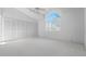 Bedroom featuring a vaulted ceiling, large window, and ample closet space at 264 Woods Point Rd, Osprey, FL 34229