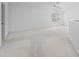 Bright white bedroom with white carpet, vaulted ceilings, and an arched window at 264 Woods Point Rd, Osprey, FL 34229