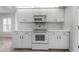 Bright kitchen with white cabinets, a white stove, and natural lighting at 264 Woods Point Rd, Osprey, FL 34229