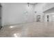 Bright open living room with tile floors, a ceiling fan, and an arched window at 264 Woods Point Rd, Osprey, FL 34229