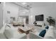 Bright, open living room with tile floors, soaring ceilings, and an abundance of natural light at 264 Woods Point Rd, Osprey, FL 34229