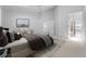 Bright main bedroom featuring neutral tones, a king bed, ensuite bathroom, and sitting area at 264 Woods Point Rd, Osprey, FL 34229