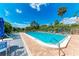 Enjoy the community pool, palm trees and lush landscaping under a beautiful blue sky at 264 Woods Point Rd, Osprey, FL 34229
