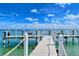 Wooden community dock extending into the calm waters at 380 Gulf Of Mexico Dr # 513, Longboat Key, FL 34228