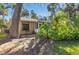 Backyard featuring lush greenery and screen enclosed porch at 5071 Village Gardens Dr # 5, Sarasota, FL 34234