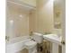 Cozy bathroom featuring a tub and a pedestal sink at 5071 Village Gardens Dr # 5, Sarasota, FL 34234