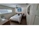 Cozy bedroom with wood floors, ceiling fan, and a comfortable queen-sized bed at 5071 Village Gardens Dr # 5, Sarasota, FL 34234