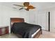 Bedroom features a ceiling fan, closet, and wood-look floors at 5071 Village Gardens Dr # 5, Sarasota, FL 34234