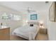 Bright bedroom showcasing a ceiling fan and a large window with plantation blinds at 5071 Village Gardens Dr # 5, Sarasota, FL 34234