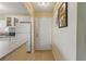 Entrance to kitchen featuring tiled flooring and white appliances at 5071 Village Gardens Dr # 5, Sarasota, FL 34234