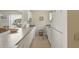 Kitchen featuring white appliances, tiled floors and laminate counters at 5071 Village Gardens Dr # 5, Sarasota, FL 34234