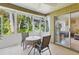 Enclosed lanai with tile flooring, comfortable seating, and beautiful backyard views at 5071 Village Gardens Dr # 5, Sarasota, FL 34234