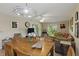 Living room featuring wood floors, ceiling fan, and dining area at 5071 Village Gardens Dr # 5, Sarasota, FL 34234