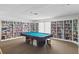 Bright recreation room featuring a pool table, carpet, and built-in bookshelves filled with books and games at 5071 Village Gardens Dr # 5, Sarasota, FL 34234