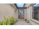 Back patio with double doors, lush plants, and a stone paved floor at 12663 Fontana Loop, Bradenton, FL 34211