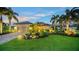 Well-maintained house with lush landscaping, and a brick paved driveway at dusk at 12663 Fontana Loop, Bradenton, FL 34211