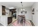Kitchen and dining area with dark wood cabinets and a chandelier at 8905 Manor Loop # 205, Lakewood Ranch, FL 34202