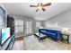 Open living space with hardwood floors, blue sofa and a view into the kitchen at 8905 Manor Loop # 205, Lakewood Ranch, FL 34202