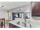 Kitchen with granite countertops, double sink, and views into the living room at 8905 Manor Loop # 205, Lakewood Ranch, FL 34202