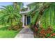 Condo entrance with teal door and tropical landscaping at 8905 Manor Loop # 205, Lakewood Ranch, FL 34202