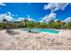Community pool with lounge chairs and patio area at 8905 Manor Loop # 205, Lakewood Ranch, FL 34202