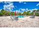 Relaxing pool area with tables, chairs, and umbrellas at 8905 Manor Loop # 205, Lakewood Ranch, FL 34202