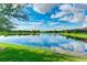 Scenic view of a tranquil lake with lush landscaping and homes at 229 Corelli Dr, Nokomis, FL 34275