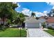 Well-maintained single story home, gray garage door, and neatly landscaped front yard at 5933 San Michelle Dr, Sarasota, FL 34243