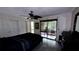 Bedroom with a king-size bed, access to a patio, and ceiling fan at 5071 Village Gardens Dr # 5, Sarasota, FL 34234