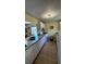Bright kitchen with white cabinets, granite counters, and tile floor at 5071 Village Gardens Dr # 5, Sarasota, FL 34234