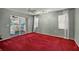 Well-lit bedroom with red carpet and sliding doors to sunroom at 5018 25Th E St, Bradenton, FL 34203