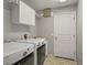 Laundry room with washer, dryer, utility sink, and overhead cabinets at 5018 25Th E St, Bradenton, FL 34203