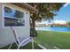 Peaceful backyard with water view, lush grass, and mature trees at 5018 25Th E St, Bradenton, FL 34203