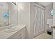 Clean bathroom with single sink vanity, shower/tub combo, and linen storage at 5018 25Th E St, Bradenton, FL 34203