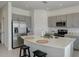 Modern kitchen with a large island, stainless steel appliances, and grey cabinets at 5725 Haven Ter, Nokomis, FL 34275