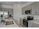 Modern kitchen with stainless steel appliances and white quartz countertops at 5725 Haven Ter, Nokomis, FL 34275
