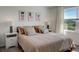 Main bedroom with neutral tones and window view at 5725 Haven Ter, Nokomis, FL 34275