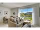 Spacious living area with a sectional sofa, offering a relaxing view of the lake at 5725 Haven Ter, Nokomis, FL 34275