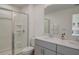 Bathroom with double vanity, large mirror and shower at 5725 Haven Ter, Nokomis, FL 34275