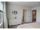 Bedroom with white dresser and access to bathroom and closet at 5725 Haven Ter, Nokomis, FL 34275