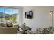 Cozy living room features a comfy sofa and large window overlooking a peaceful lake at 5725 Haven Ter, Nokomis, FL 34275