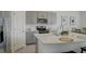 Open concept kitchen with modern gray cabinets and a large island at 5725 Haven Ter, Nokomis, FL 34275