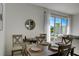 Modern dining area with a table and chairs near a sliding glass door to a patio at 5725 Haven Ter, Nokomis, FL 34275