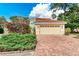 House exterior with a brick driveway and lush landscaping at 264 Woods Point Rd, Osprey, FL 34229