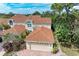 Aerial view of a house with a tile roof and two-car garage at 264 Woods Point Rd, Osprey, FL 34229