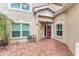 Inviting front entry with brick pavers, a charming door, and a small sitting area at 264 Woods Point Rd, Osprey, FL 34229
