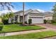 One story house with a palm tree and brick driveway at 7160 Spikerush Ct, Lakewood Ranch, FL 34202